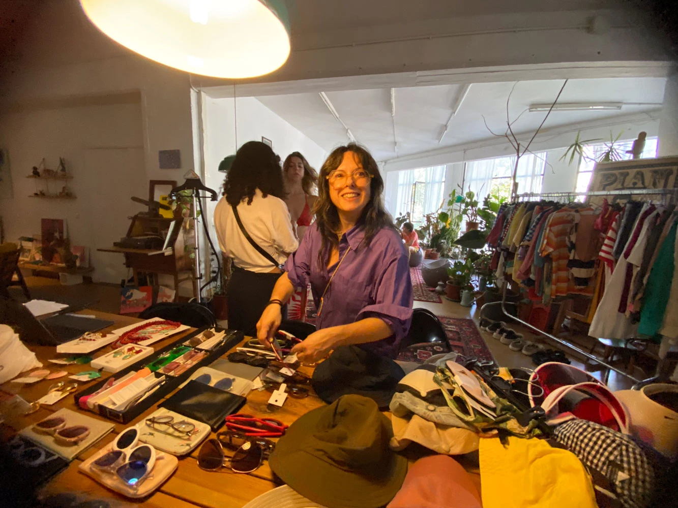 Stylist preparing glasses, hats and wardrobe for a Glassy Films shoot