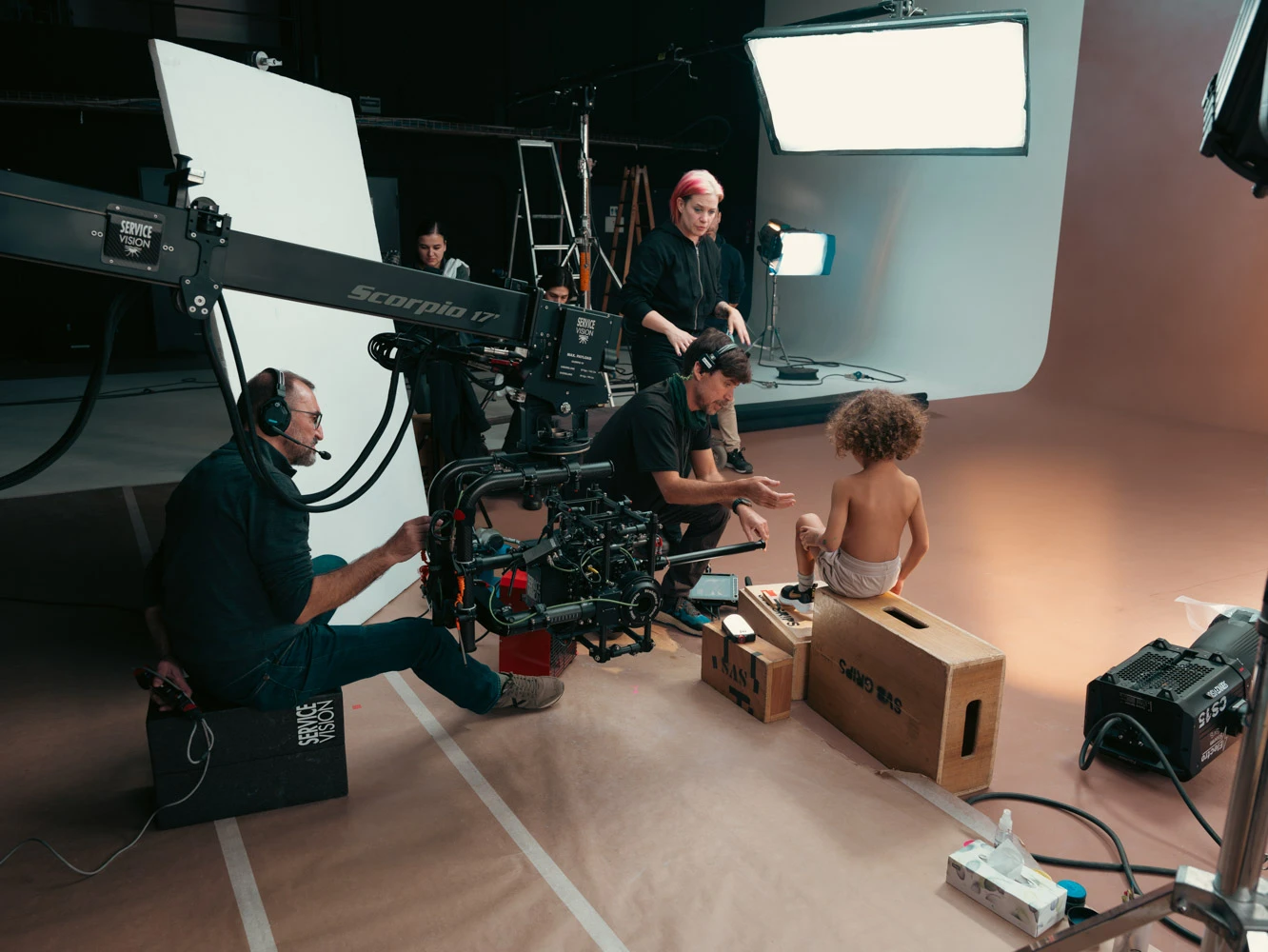 Glassy Films crew with a crane camera filming a toddler sitting on apple boxes